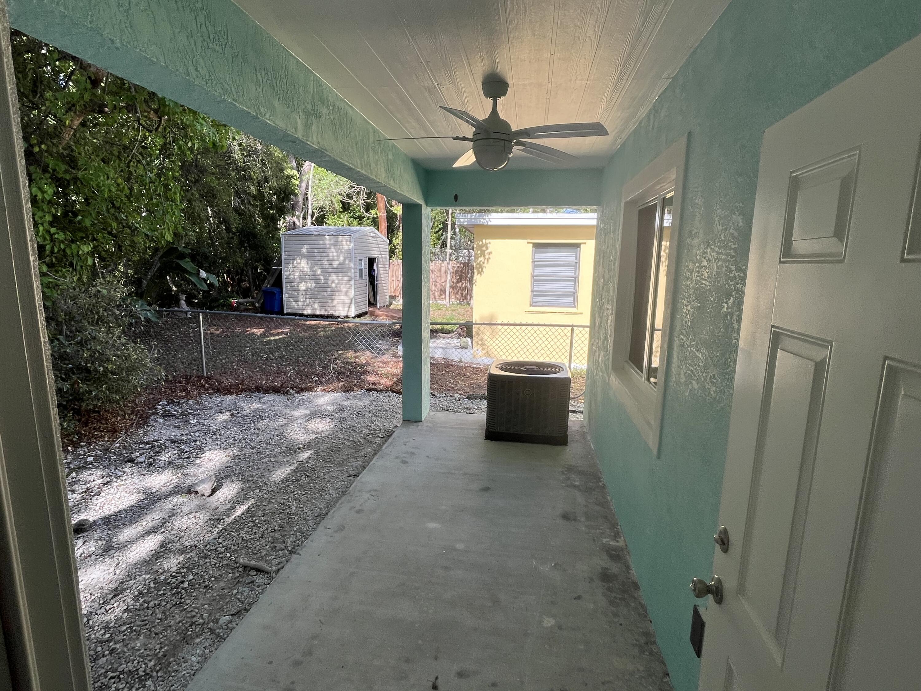 639 Cabrera Street Key Largo, FL 33037 - Photo 5 of 24 a view of a hallway with a window and fire pit