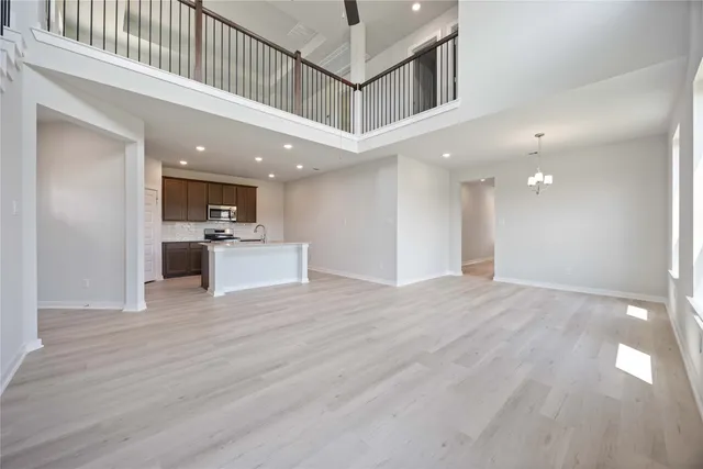 a view of a hallway with kitchen and microwave