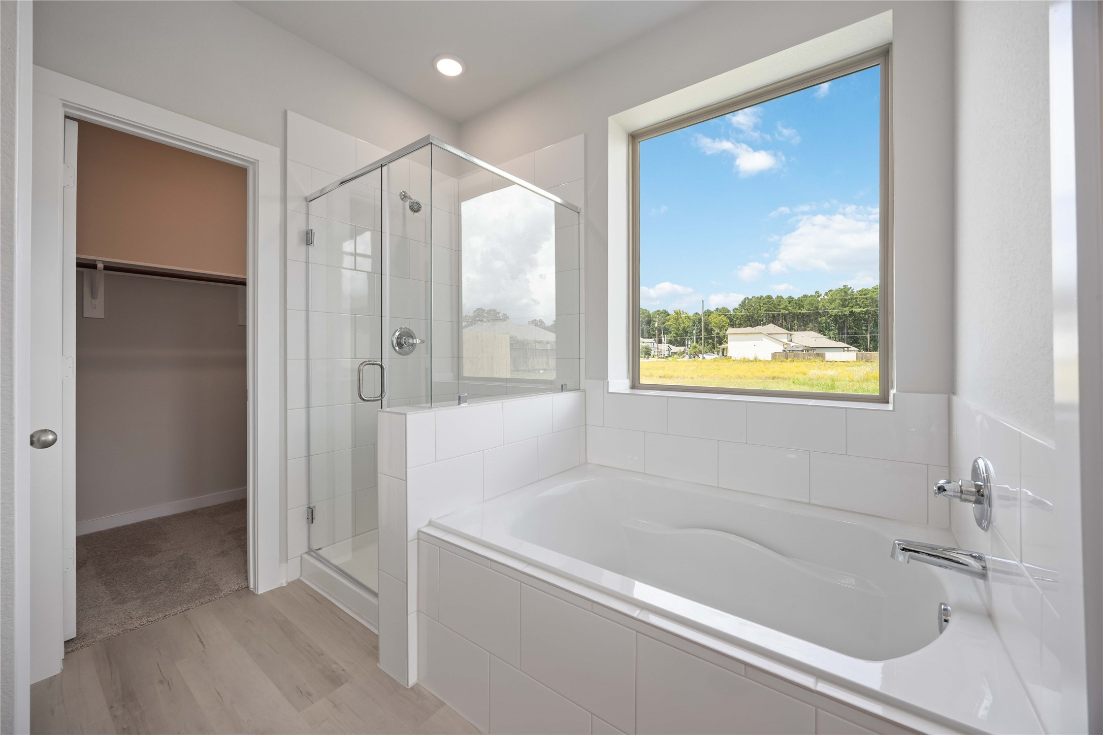 10943 Independence Road Cleveland, TX 77328 - Photo 20 of 31 a bathroom with a bathtub and a shower