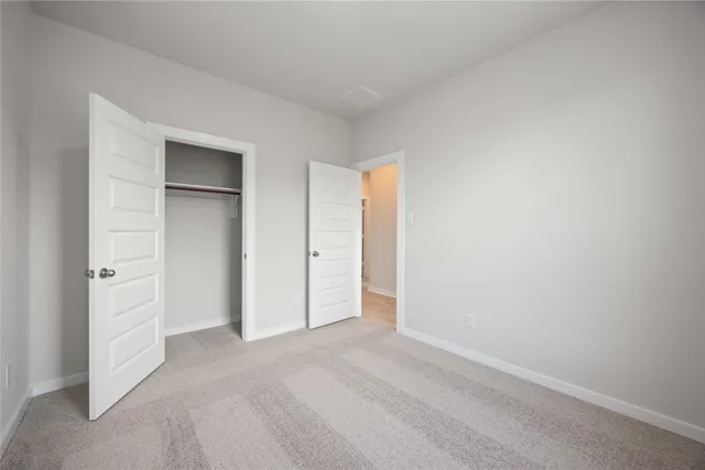 a view of an empty room and closet area