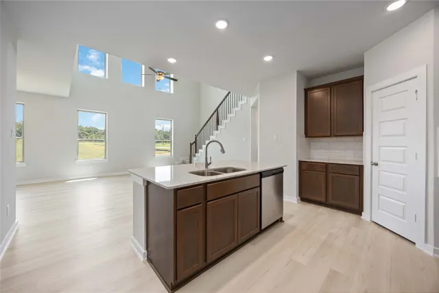 a kitchen with a sink a stove and cabinets