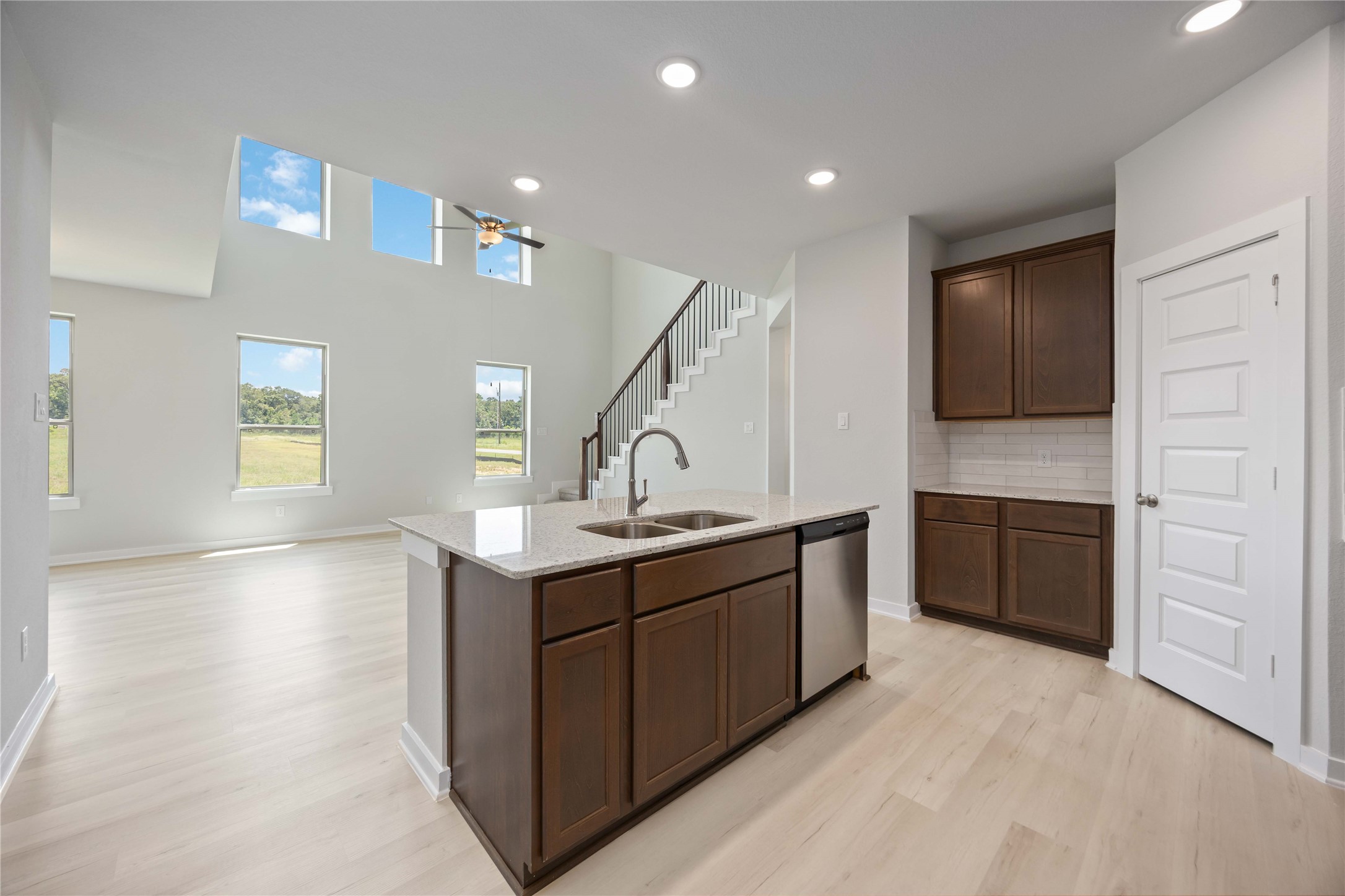 10943 Independence Road Cleveland, TX 77328 - Photo 7 of 31 a kitchen with a sink a stove and cabinets