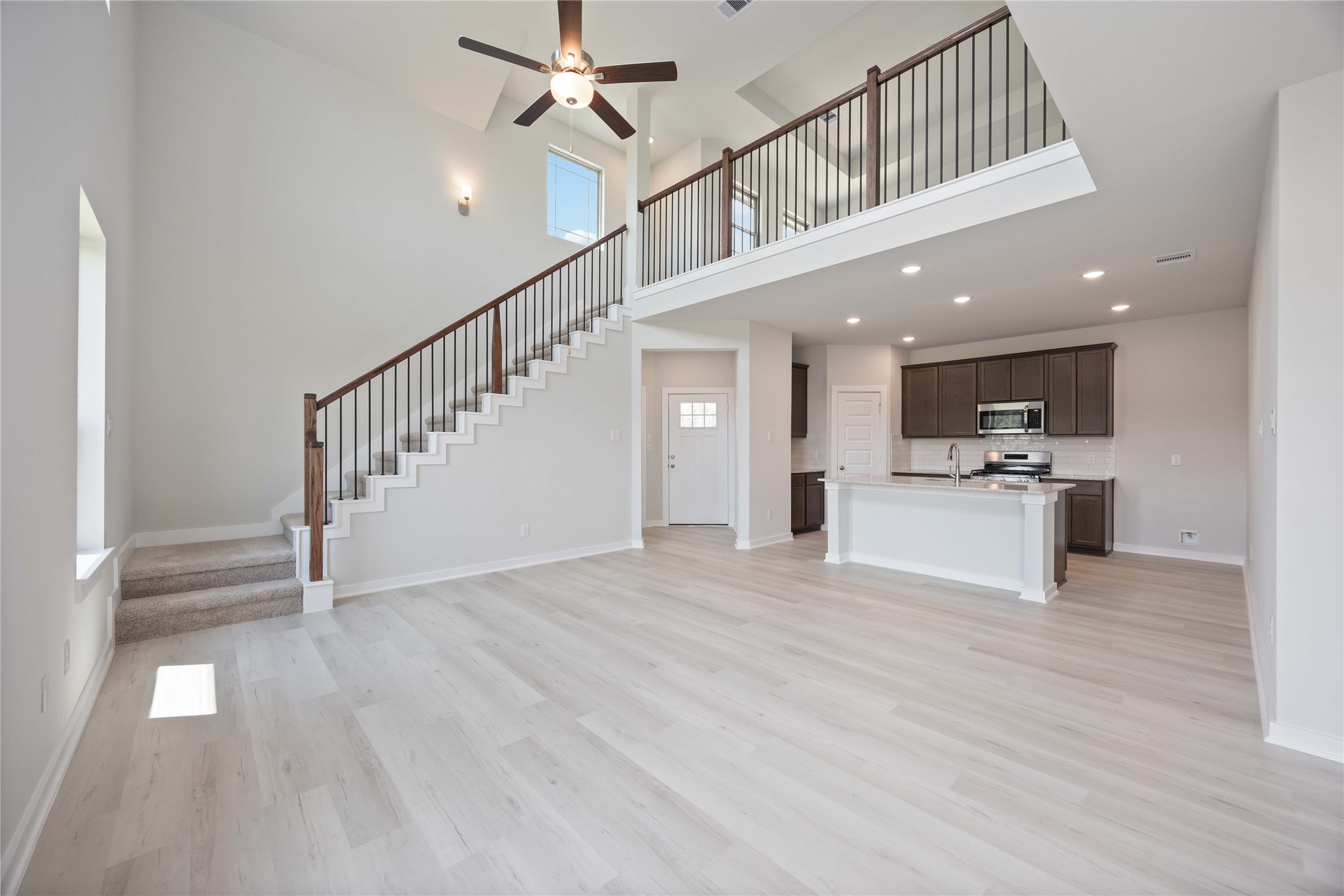 10943 Independence Road Cleveland, TX 77328 - Photo 9 of 31 a view of staircase and kitchen with sink