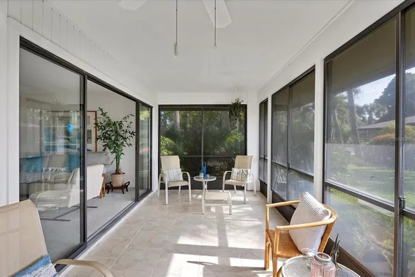 a view of a porch with chairs and backyard
