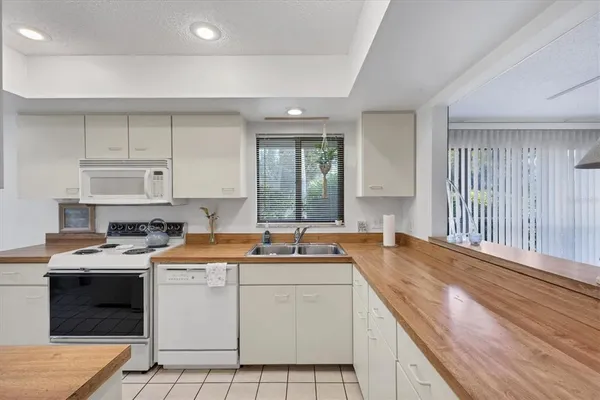 a kitchen with a sink a stove and refrigerator