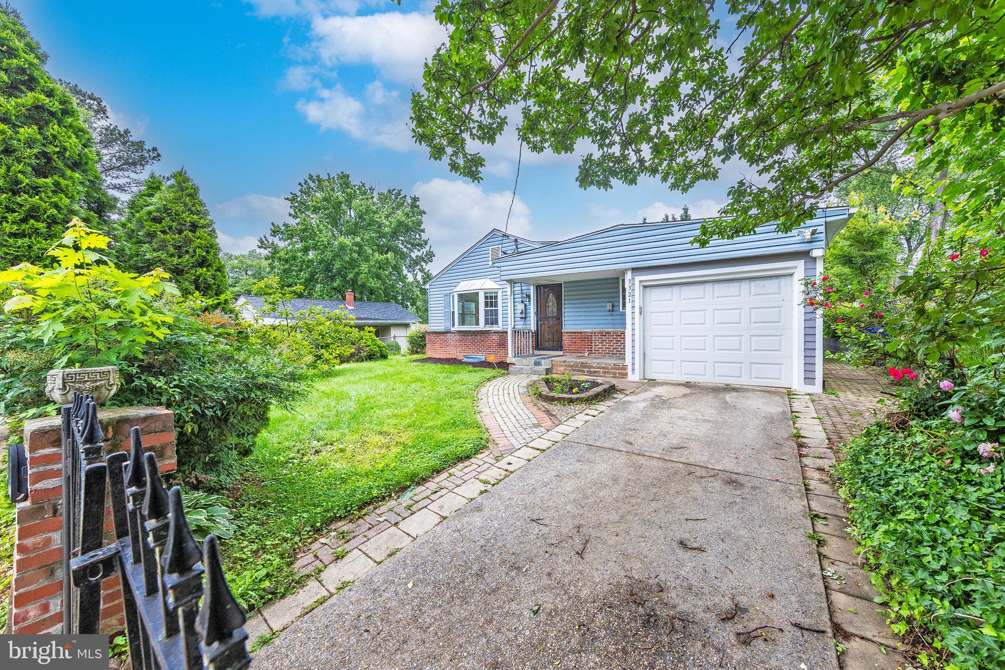 3321 Clay Street Silver Spring, MD 20902 - Photo 40 of 41 a front view of a house with a yard and a garage