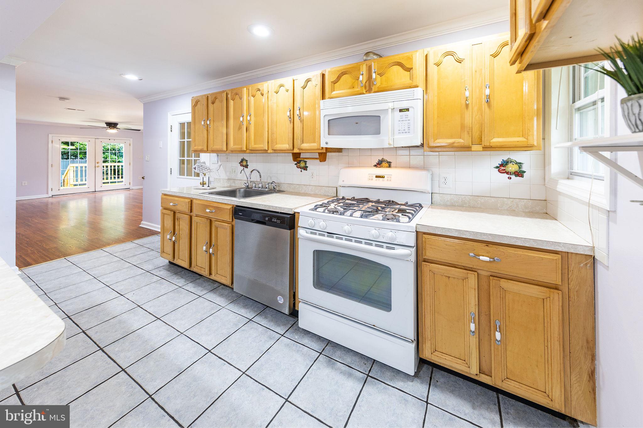 3321 Clay Street Silver Spring, MD 20902 - Photo 7 of 41 a kitchen with stainless steel appliances granite countertop a stove sink and cabinets