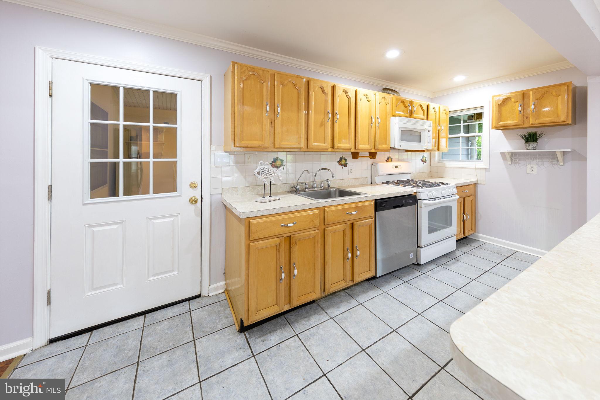 3321 Clay Street Silver Spring, MD 20902 - Photo 8 of 41 a kitchen with a sink window and cabinets