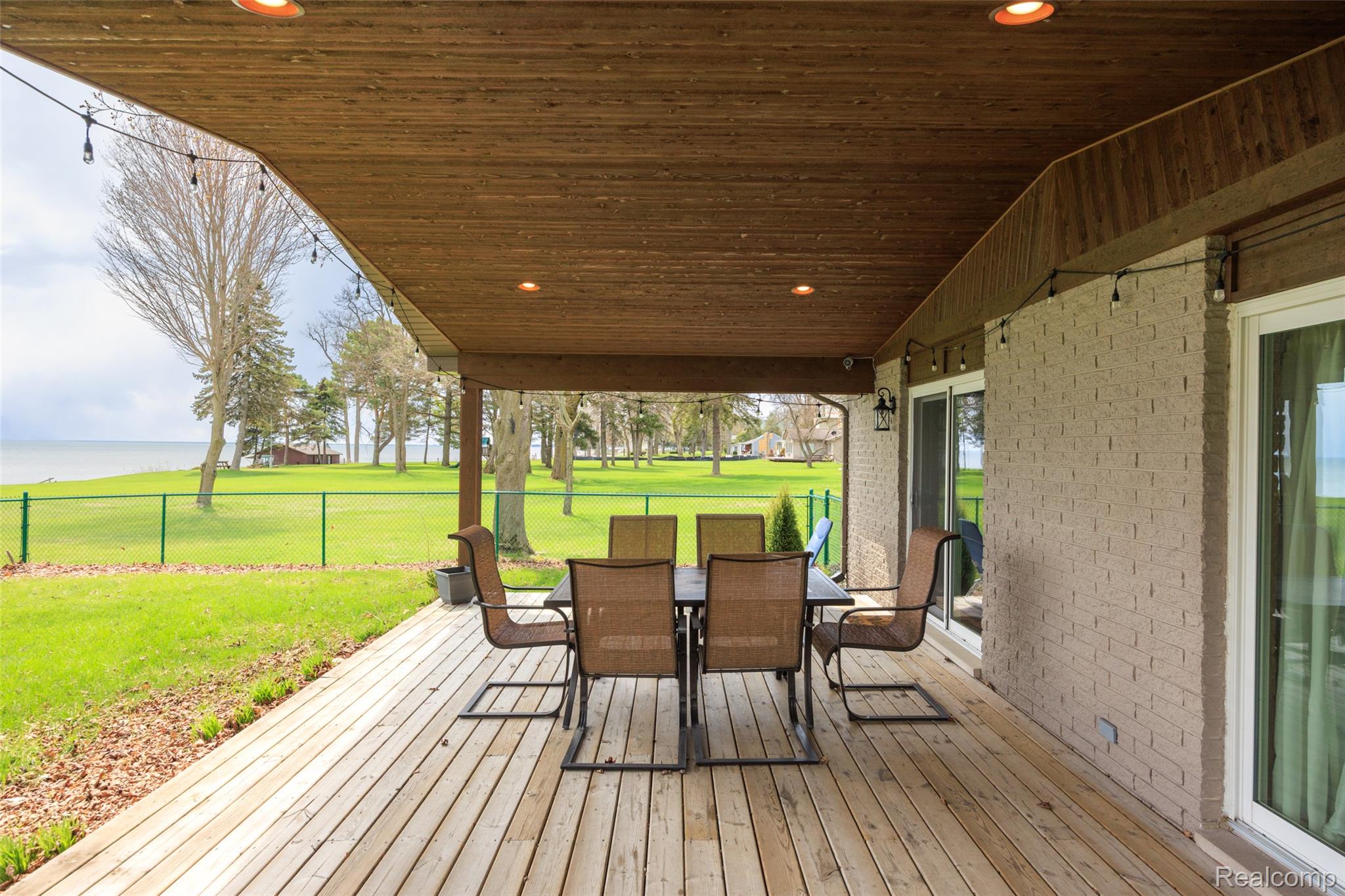 Wooden deck featuring outdoor dining space and view of golf course