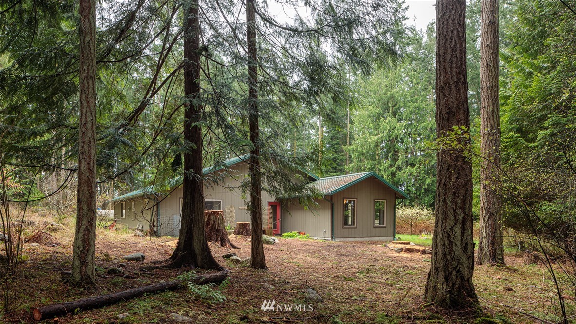53 Cross Road Lopez Island, WA 98261 - Photo 2 of 20 a dirt road with trees in front of it