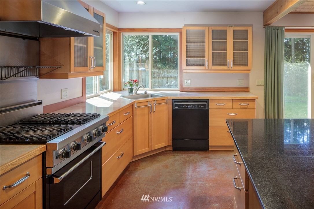 53 Cross Road Lopez Island, WA 98261 - Photo 11 of 20 a kitchen with stainless steel appliances granite countertop a stove a sink and a refrigerator
