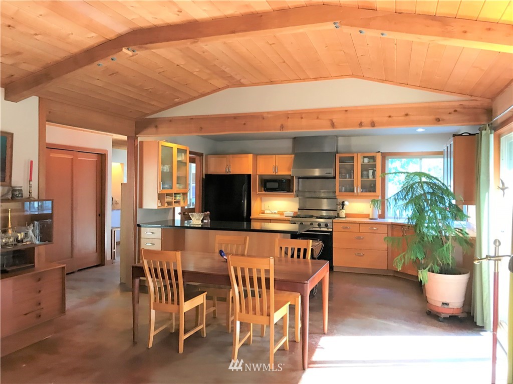 53 Cross Road Lopez Island, WA 98261 - Photo 6 of 20 a dining room with furniture and a kitchen area