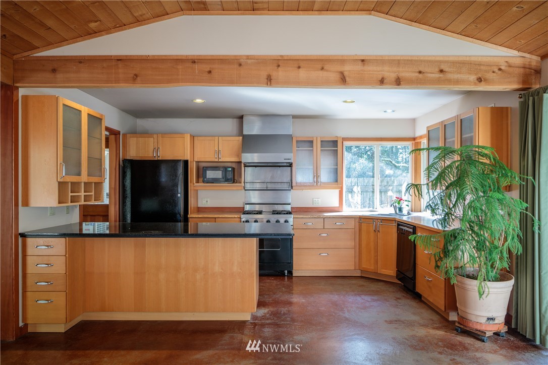 53 Cross Road Lopez Island, WA 98261 - Photo 7 of 20 a kitchen with stainless steel appliances granite countertop a stove and a refrigerator