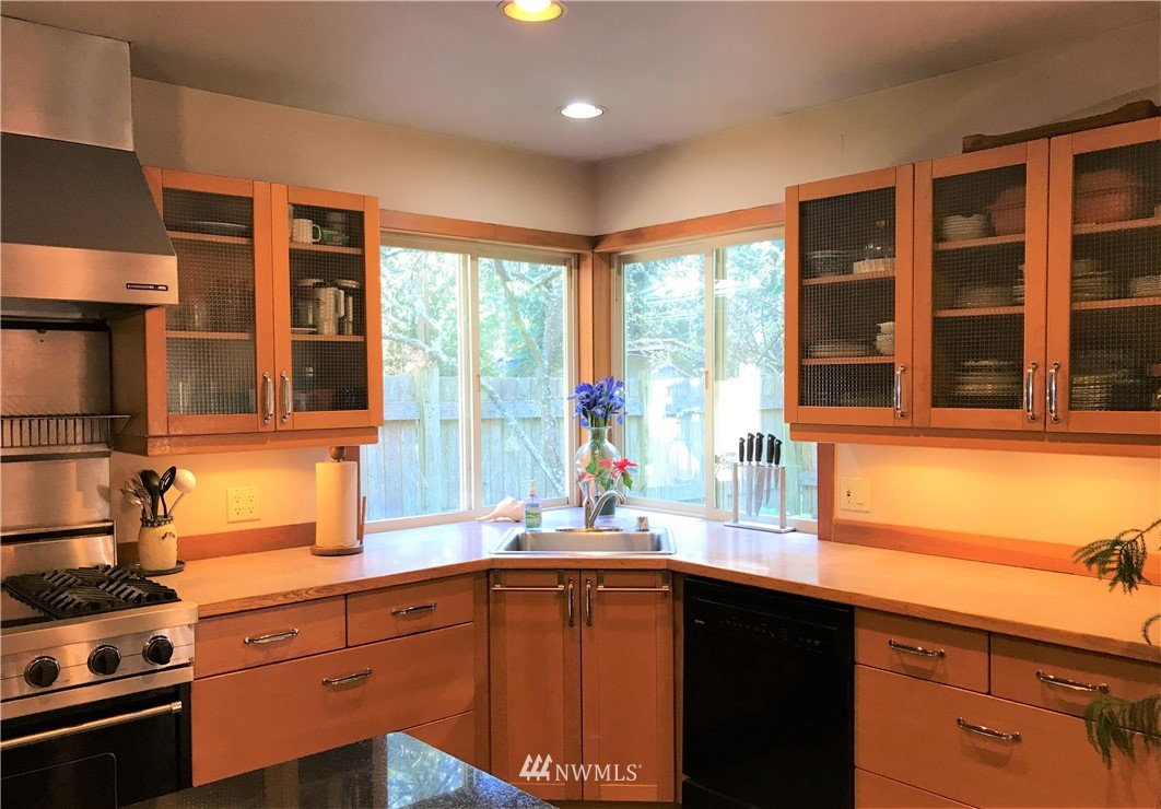 53 Cross Road Lopez Island, WA 98261 - Photo 10 of 20 a kitchen with stainless steel appliances granite countertop a sink and wooden cabinets