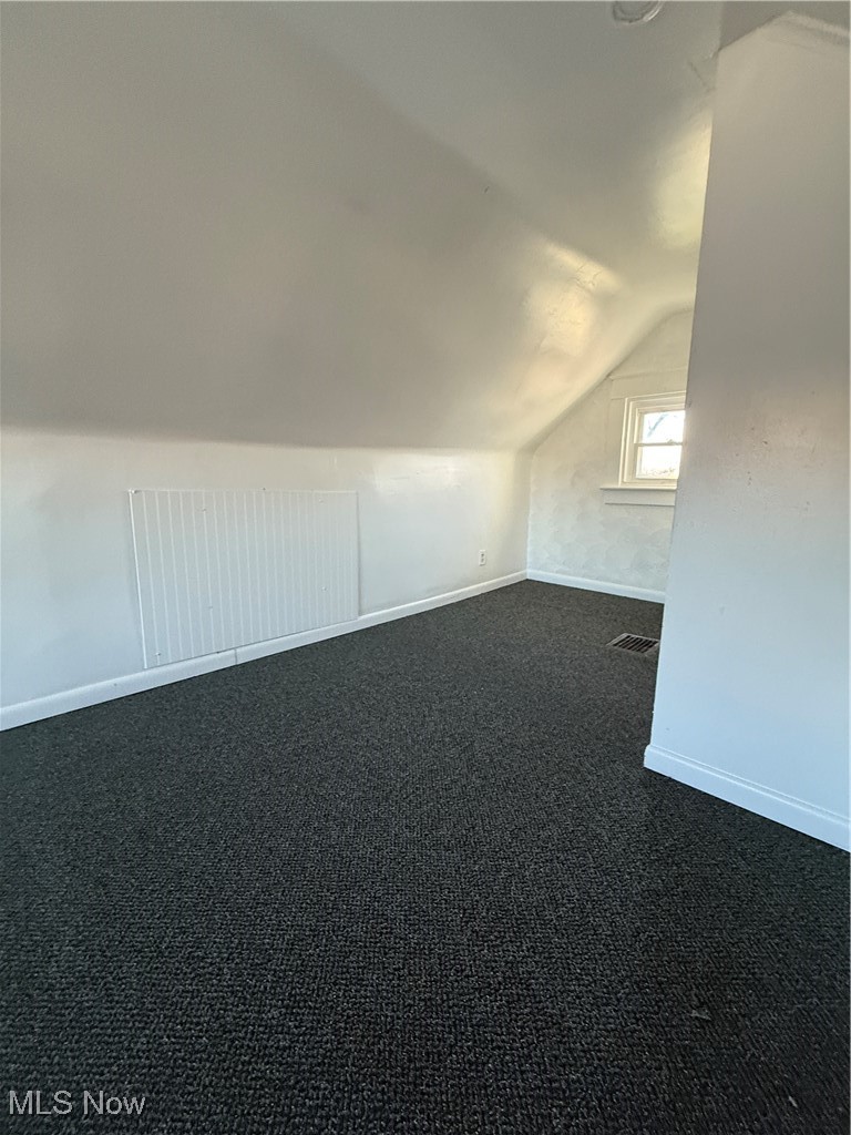 580 Inman Street Akron, OH 44306 - Photo 8 of 12 Bonus room with dark colored carpet and vaulted ceiling