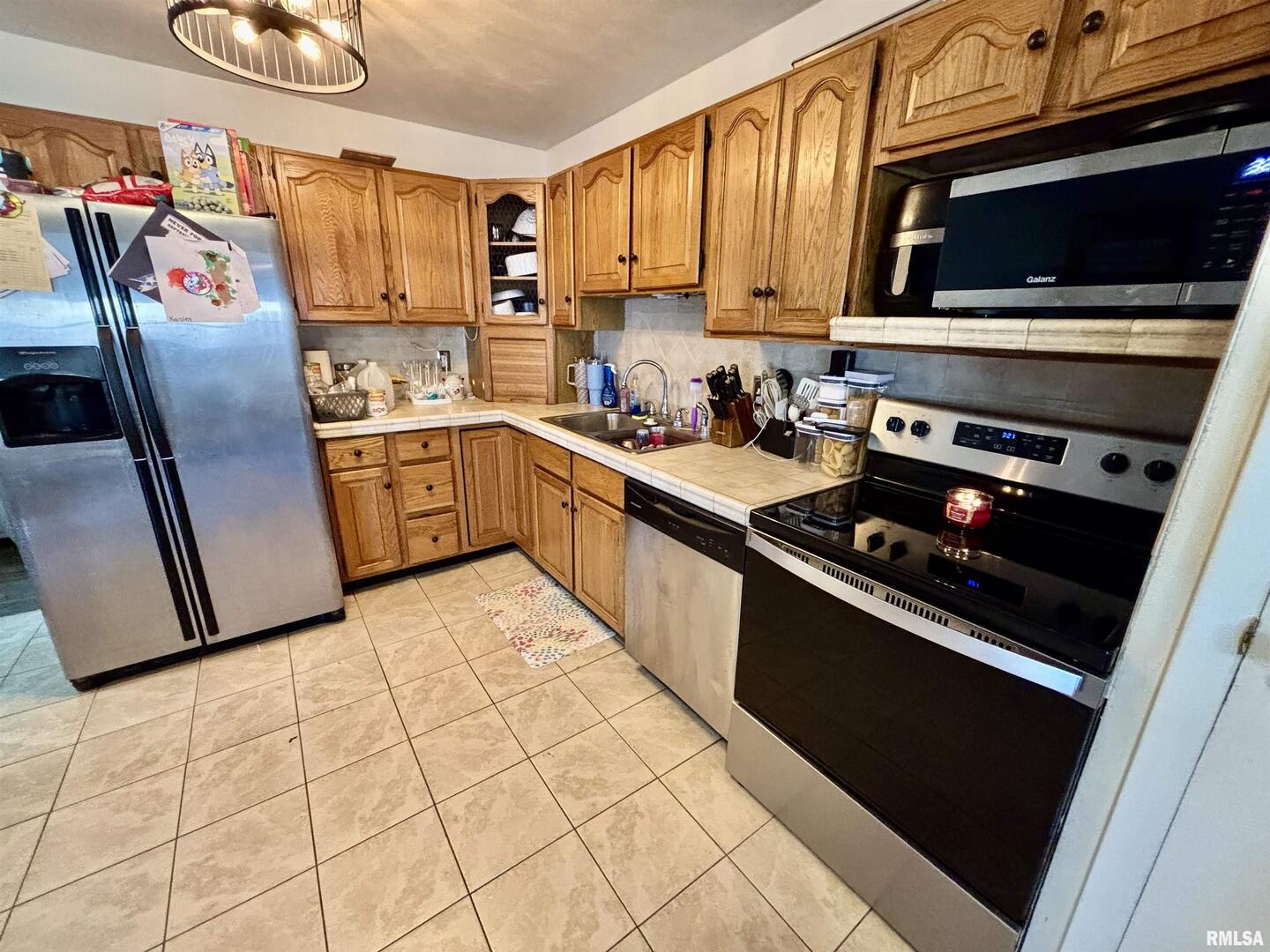 1012 West 4th Street Centralia, IL 62801 - Photo 8 of 20 a kitchen with stainless steel appliances granite countertop a stove a sink and a microwave
