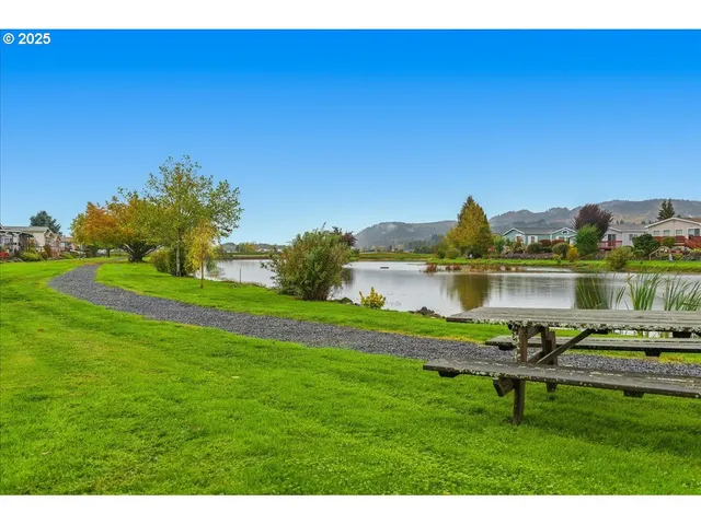 a view of a lake with houses in the back