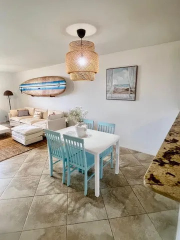 a dining room with furniture and a chandelier