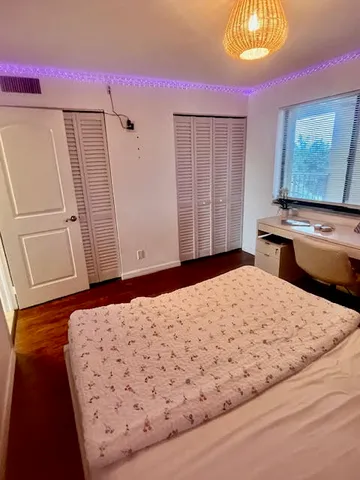 a bathroom with a double vanity sink mirror and toilet