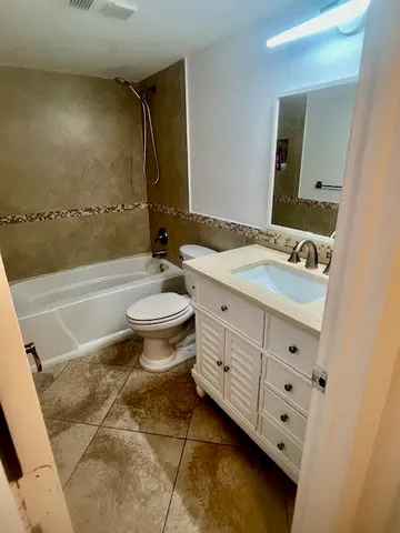 a bathroom with a toilet and a bath tub