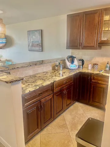 a kitchen with stainless steel appliances granite countertop a stove sink and cabinets