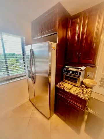 a kitchen with a refrigerator and a stove top oven