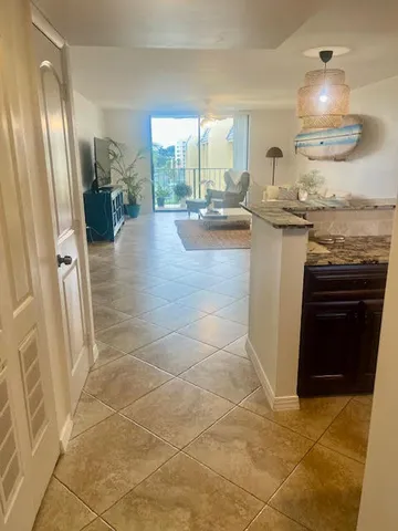 a kitchen with granite countertop a refrigerator a stove and a sink