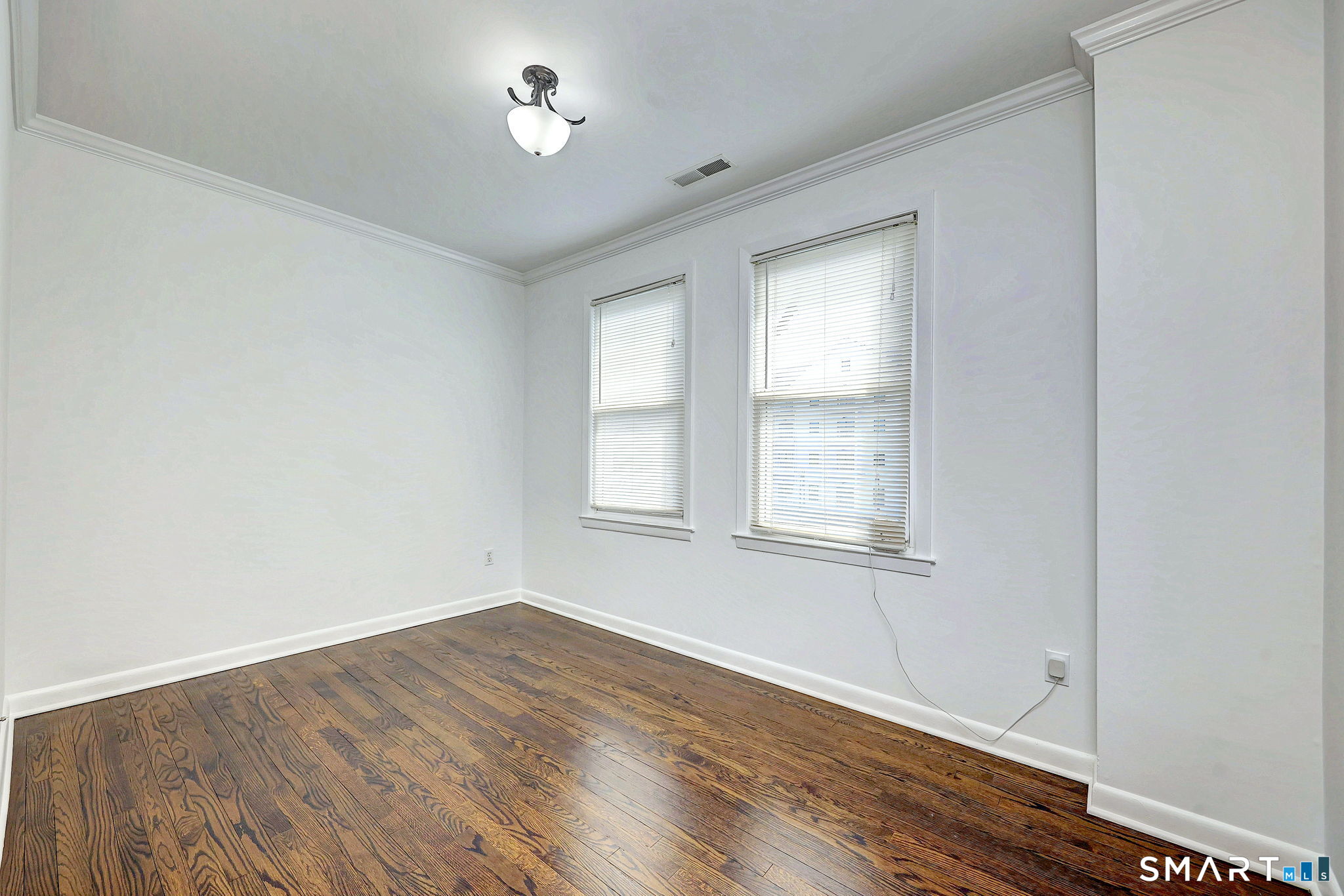 40 Yale Street Stratford, CT 06615 - Photo 20 of 31 an empty room with wooden floor and windows