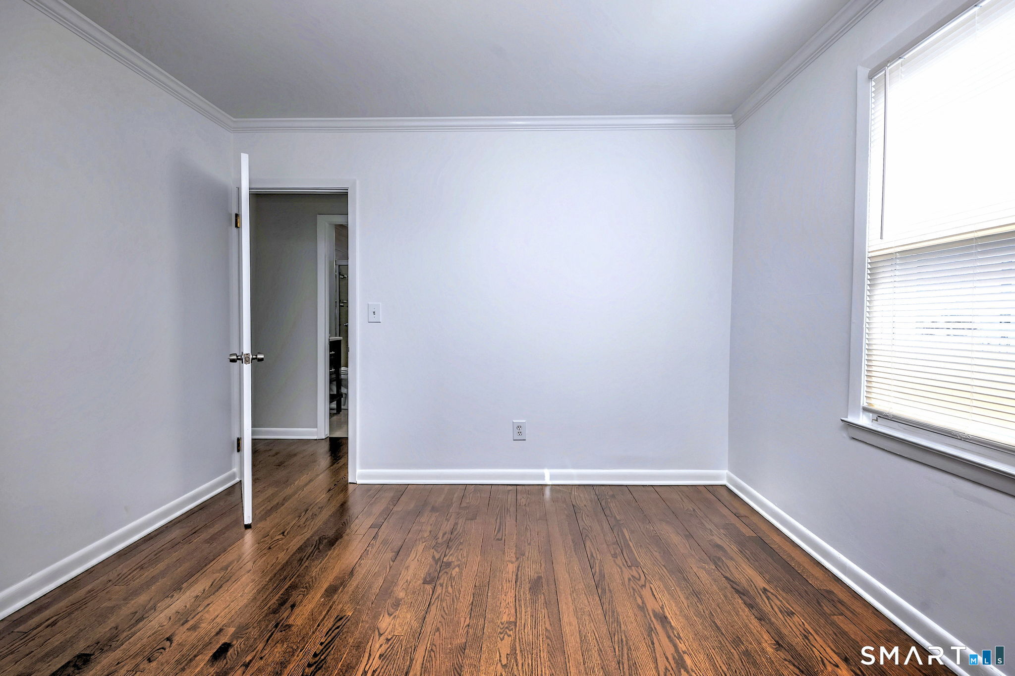 40 Yale Street Stratford, CT 06615 - Photo 21 of 31 an empty room with wooden floor and windows
