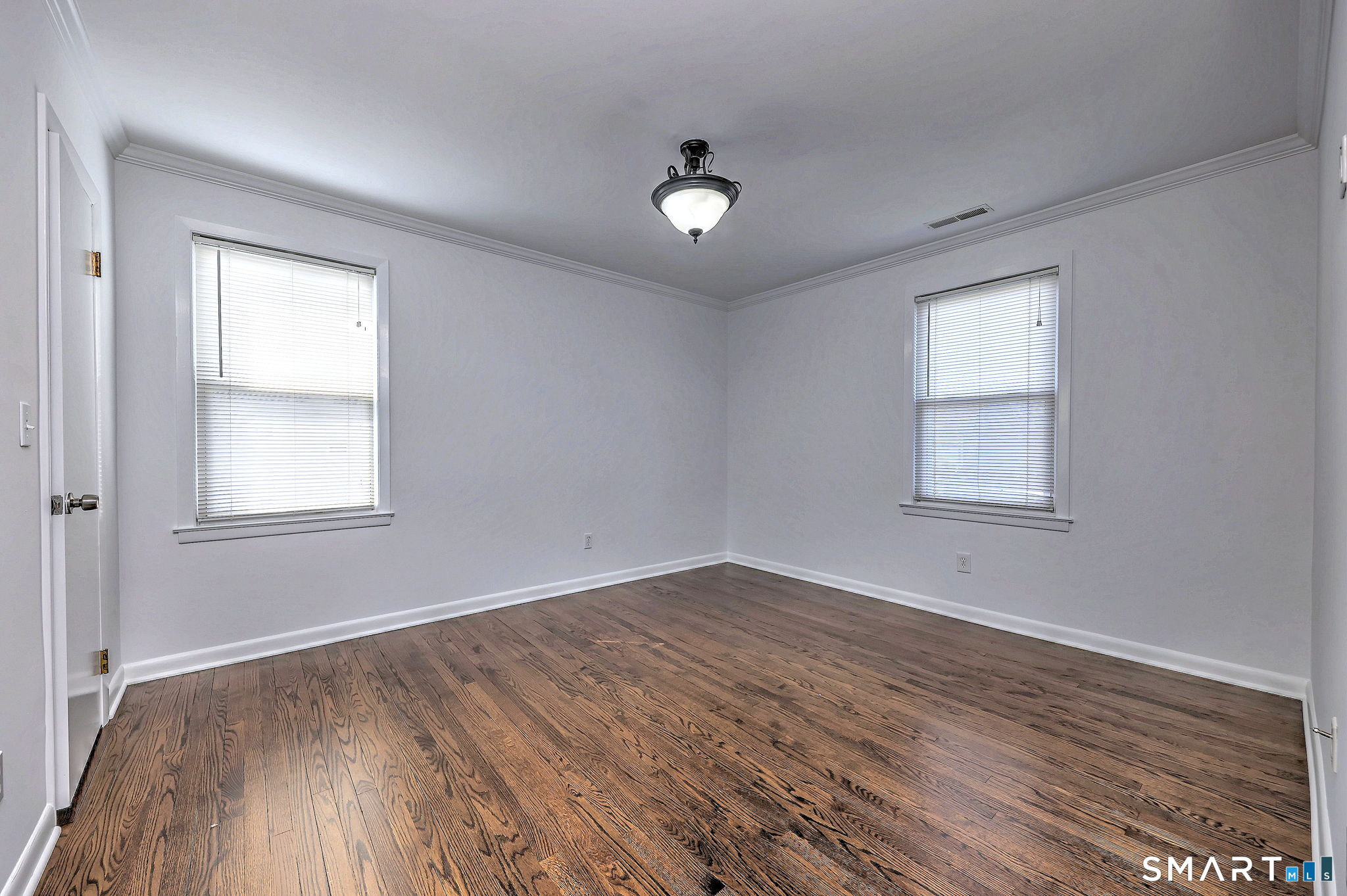 40 Yale Street Stratford, CT 06615 - Photo 22 of 31 an empty room with wooden floor and windows