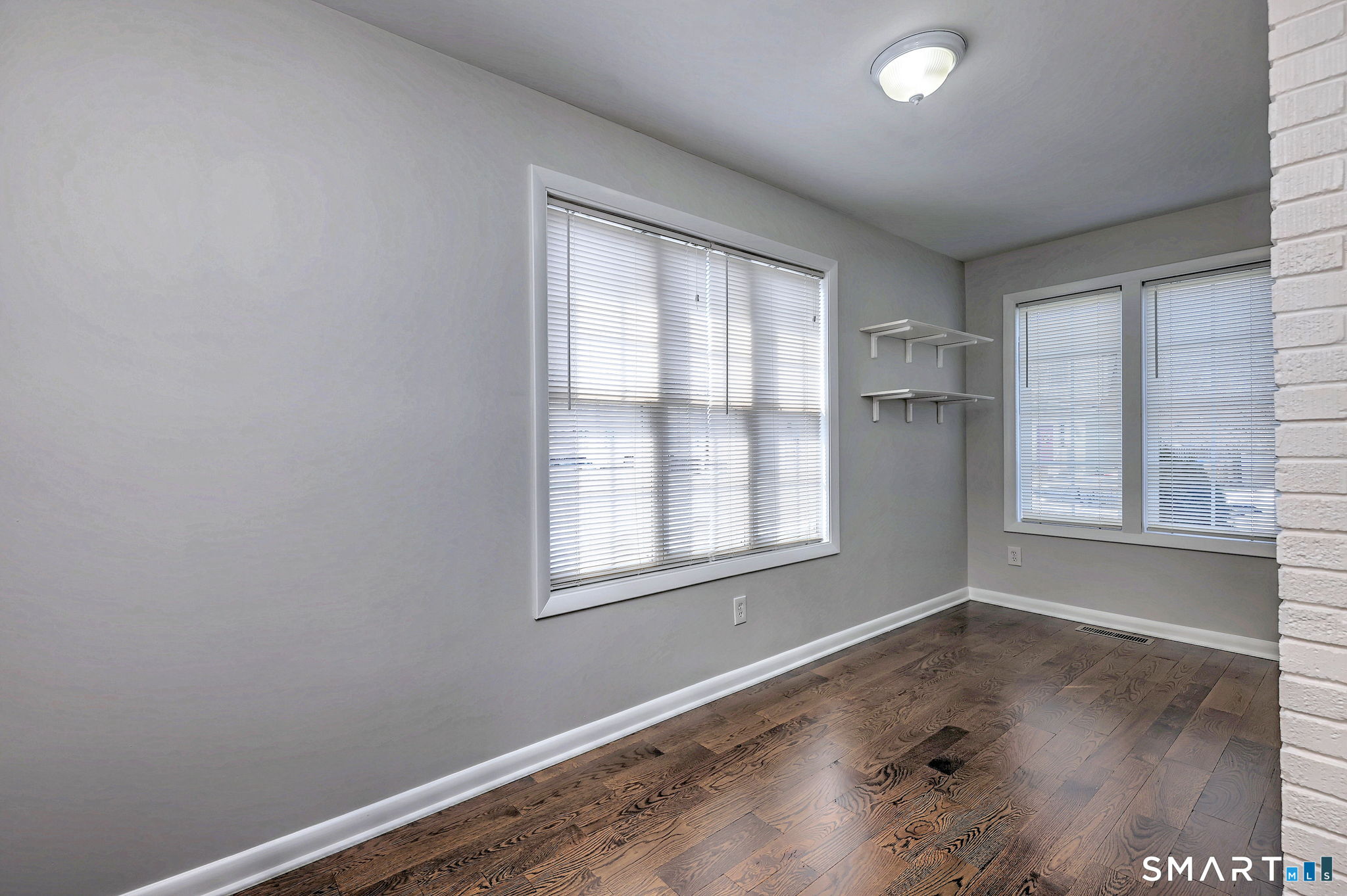 40 Yale Street Stratford, CT 06615 - Photo 23 of 31 an empty room with wooden floor and windows