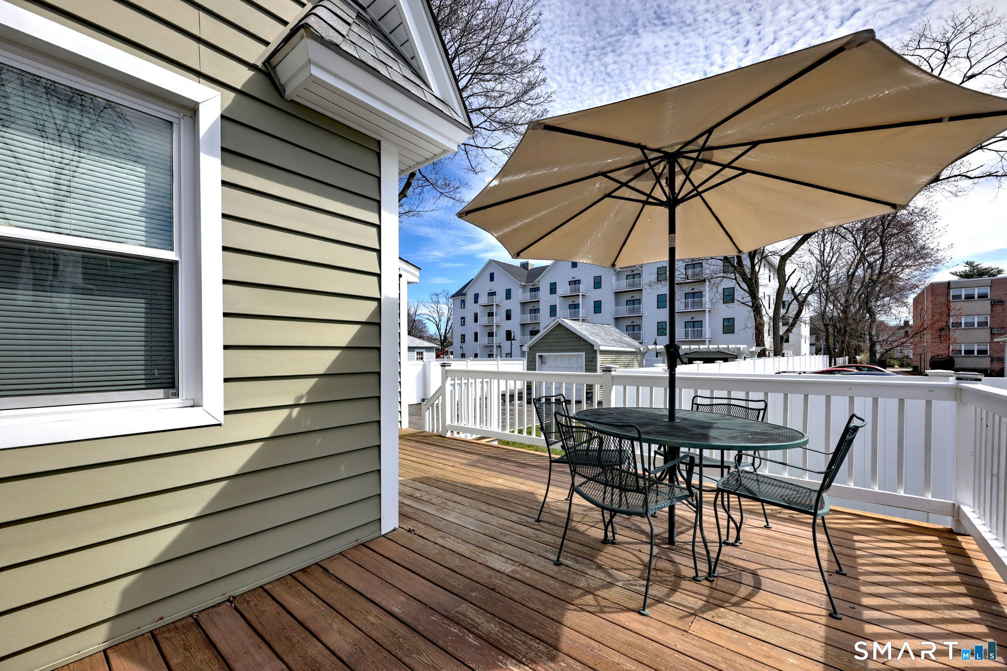 40 Yale Street Stratford, CT 06615 - Photo 29 of 31 a view of a roof deck with table and chairs under an umbrella