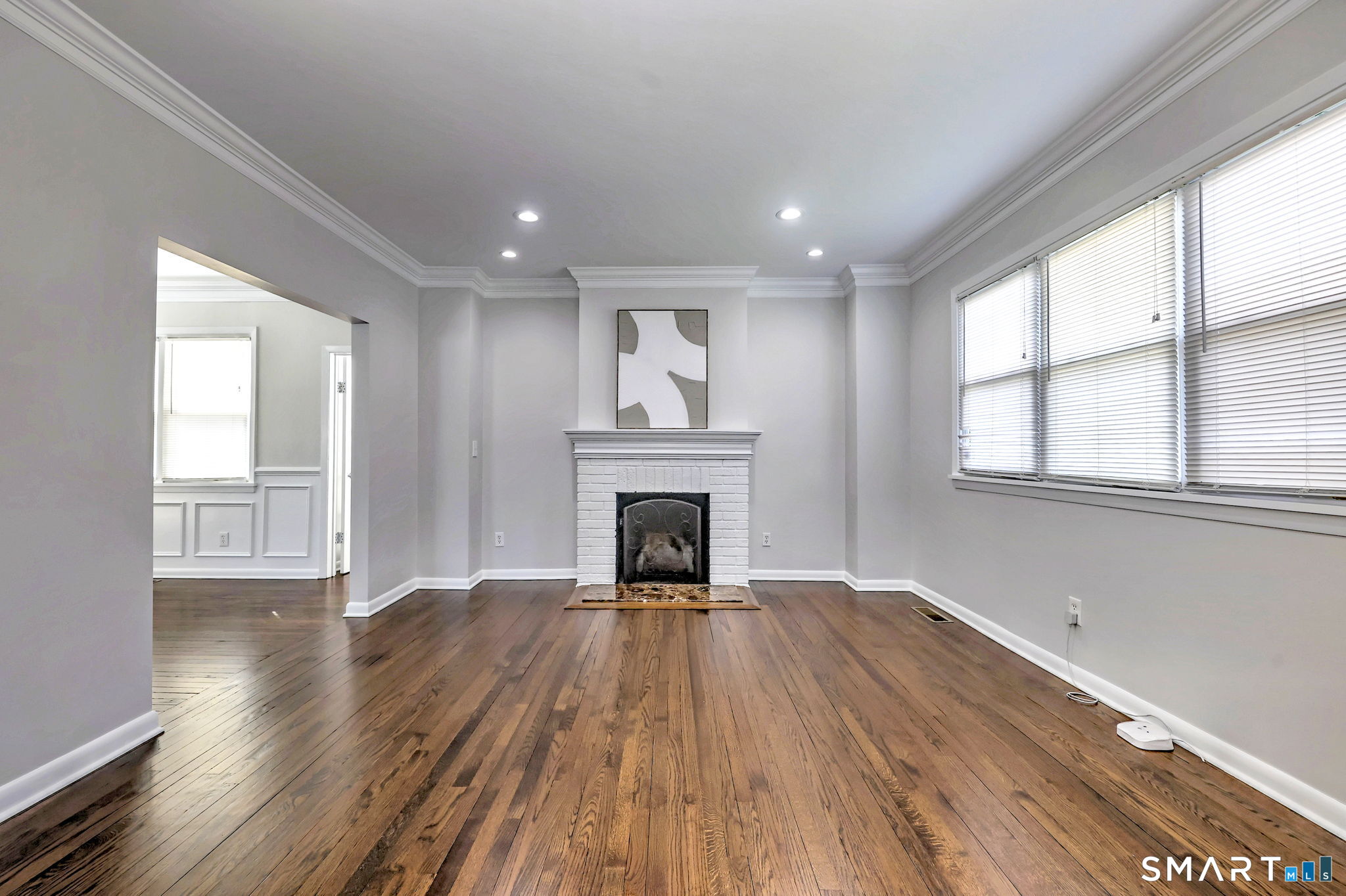 40 Yale Street Stratford, CT 06615 - Photo 4 of 31 a view of an empty room with wooden floor fireplace and windows