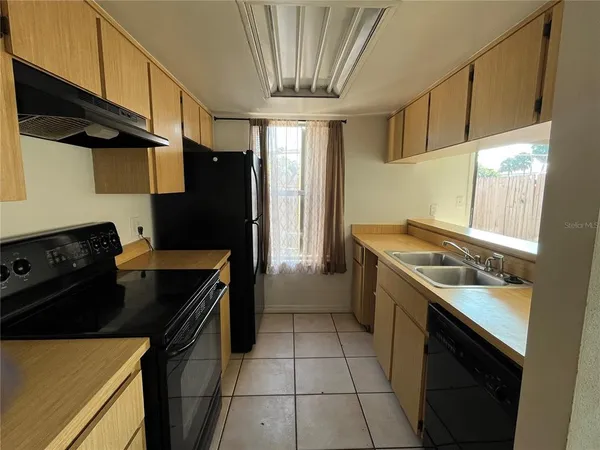 a kitchen with a stove and a refrigerator