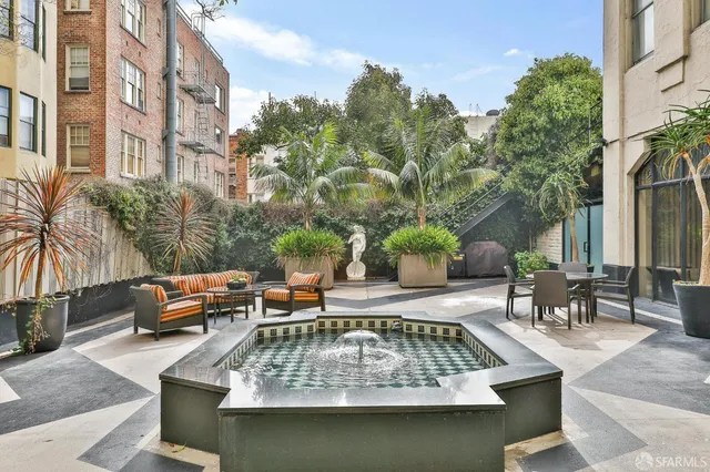 a view of a swimming pool with chairs in patio