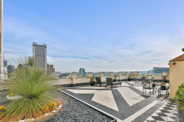 a view of a swimming pool with outdoor seating and plants