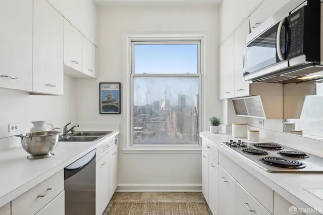 a kitchen with stainless steel appliances a sink stove and cabinets
