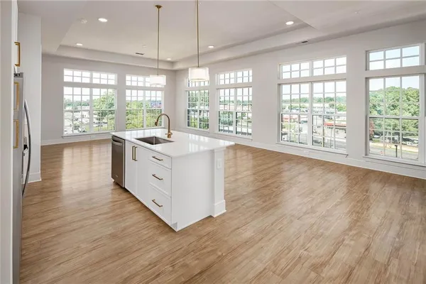 a kitchen with stainless steel appliances granite countertop a stove and a large window