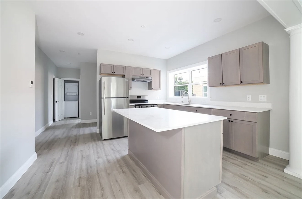 566-572 Main Street, Unit 201 Shrewsbury, MA 01545 - Photo 2 of 5 a kitchen with a sink a window and stainless steel appliances