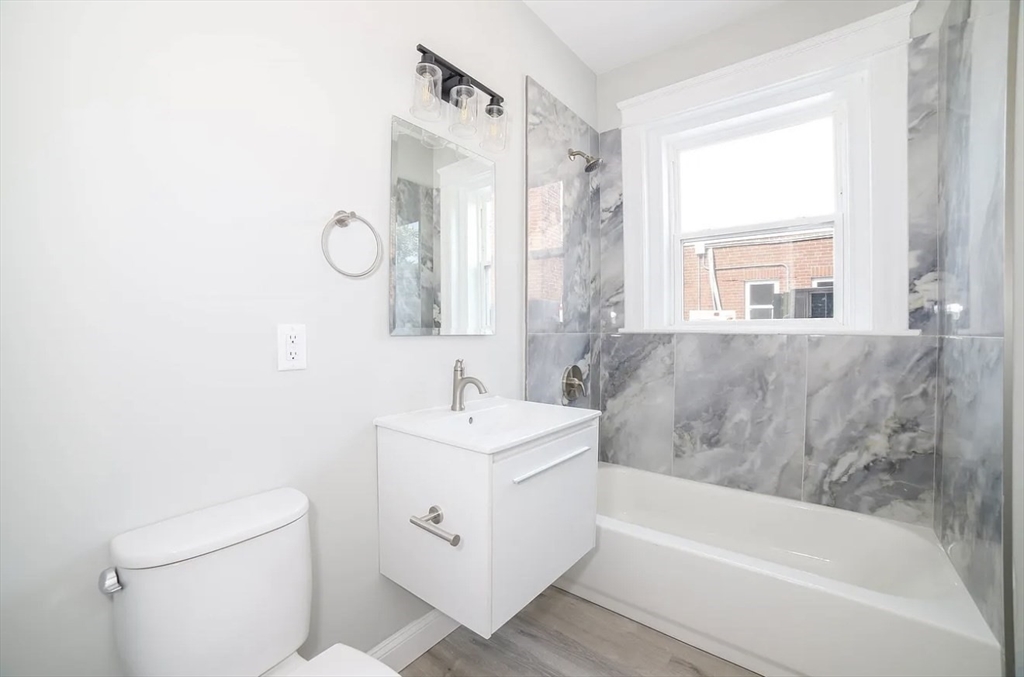 566-572 Main Street, Unit 201 Shrewsbury, MA 01545 - Photo 3 of 5 a bathroom with a sink a toilet and a bathtub