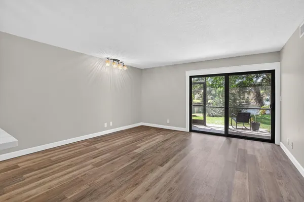 a view of room with window and hardwood floor