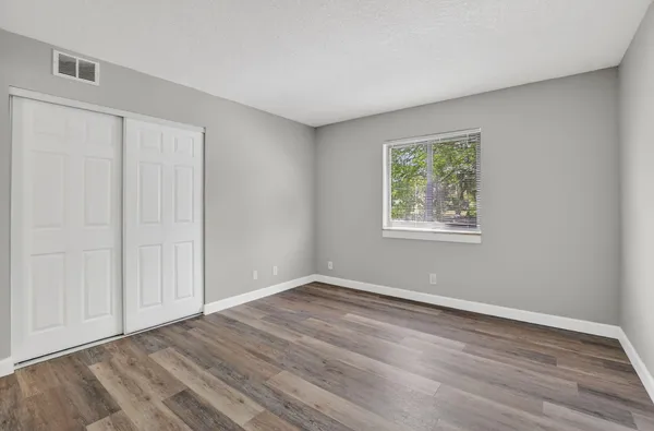 a bathroom with a granite countertop sink a toilet and mirror