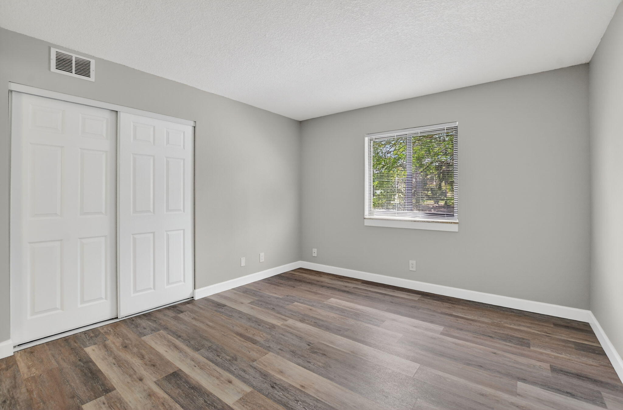 918 Southwest 9th St Circle, Unit 105 Boca Raton, FL 33486 - Photo 14 of 39 a view of room with window and hardwood floor