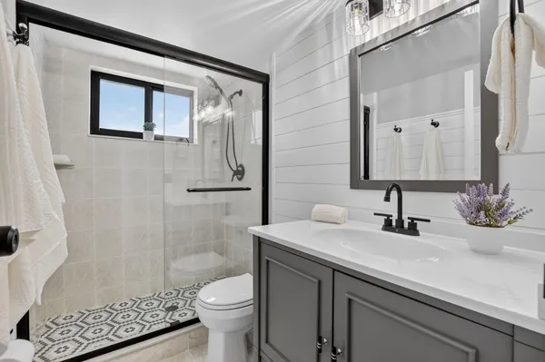 a bedroom with a bed and a potted plant