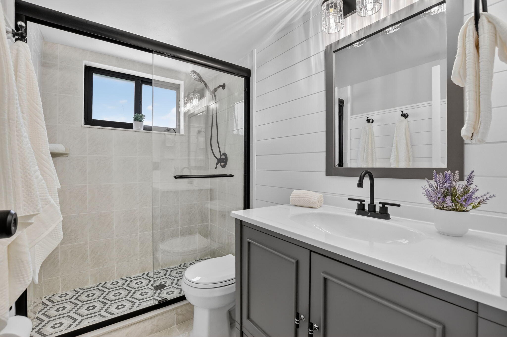 918 Southwest 9th St Circle, Unit 105 Boca Raton, FL 33486 - Photo 16 of 39 a bathroom with a sink a toilet and shower