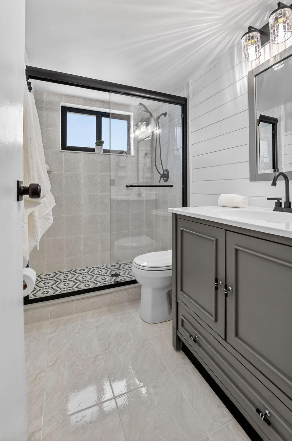 918 Southwest 9th St Circle, Unit 105 Boca Raton, FL 33486 - Photo 17 of 39 a bathroom with a granite countertop sink a toilet and mirror