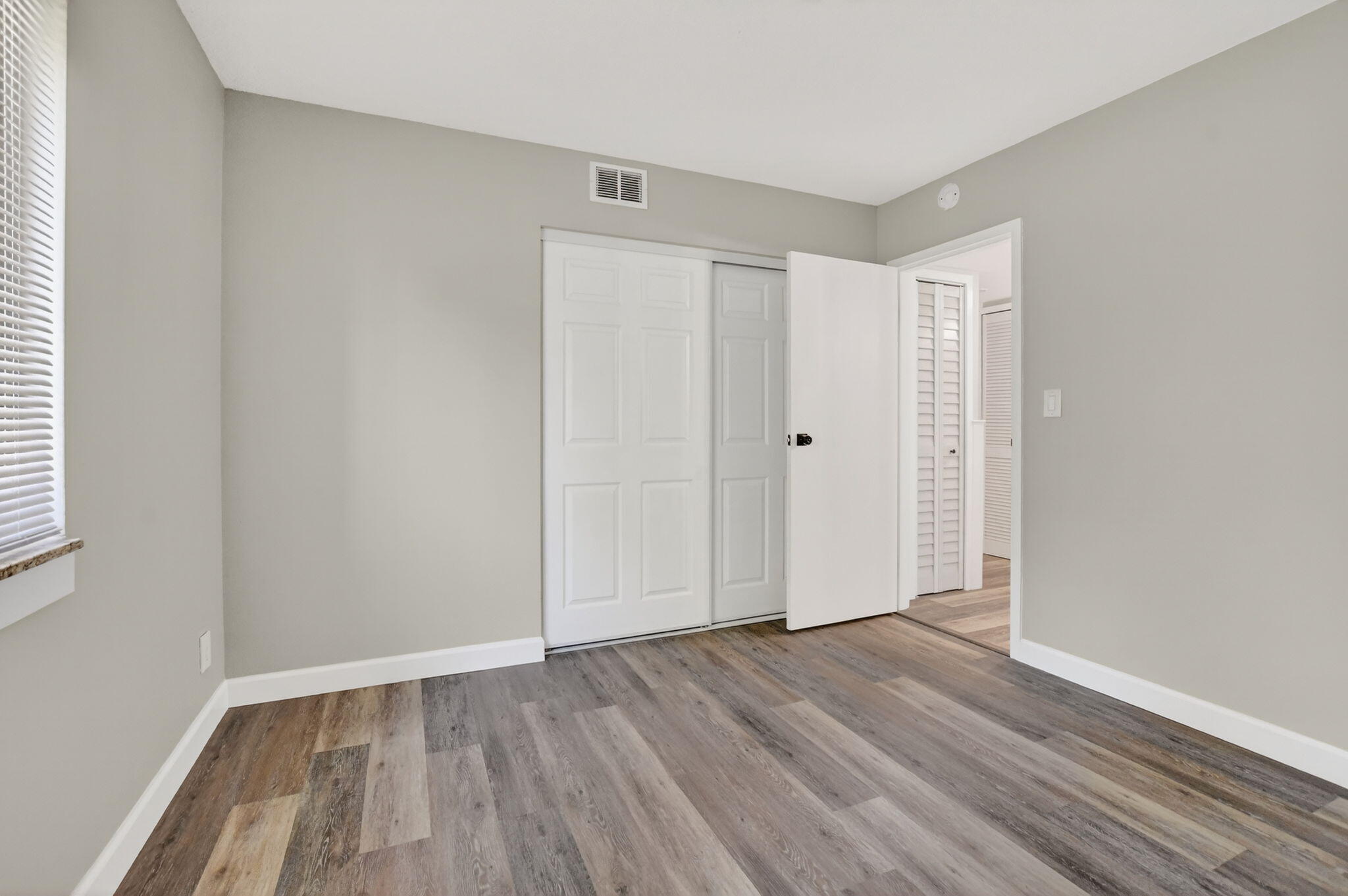 918 Southwest 9th St Circle, Unit 105 Boca Raton, FL 33486 - Photo 20 of 39 a view of an empty room with wooden floor