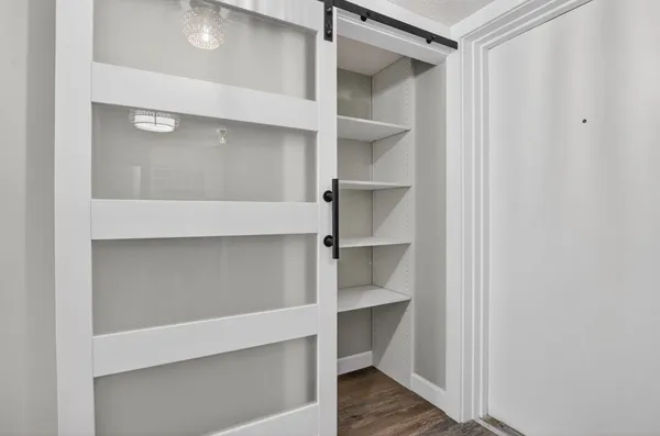 a kitchen with stainless steel appliances a sink a refrigerator and a window