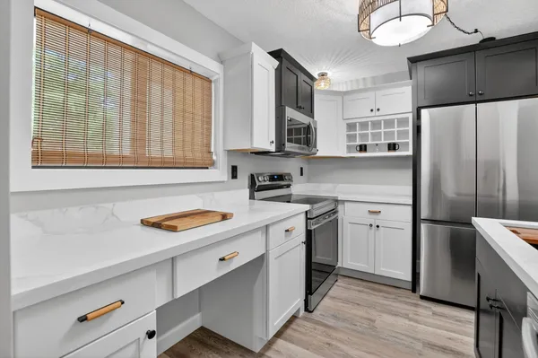 a kitchen with a sink cabinets and wooden floor