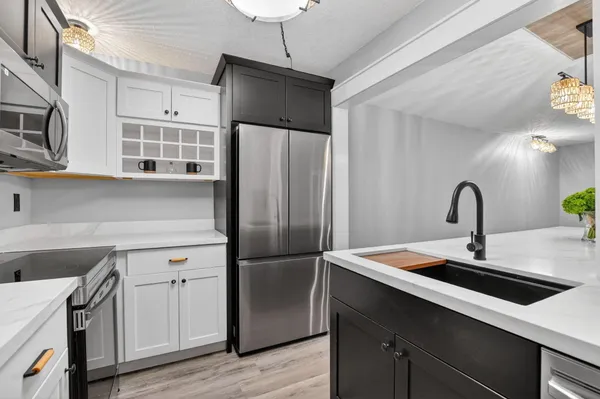 a kitchen with stainless steel appliances a refrigerator and a stove top oven